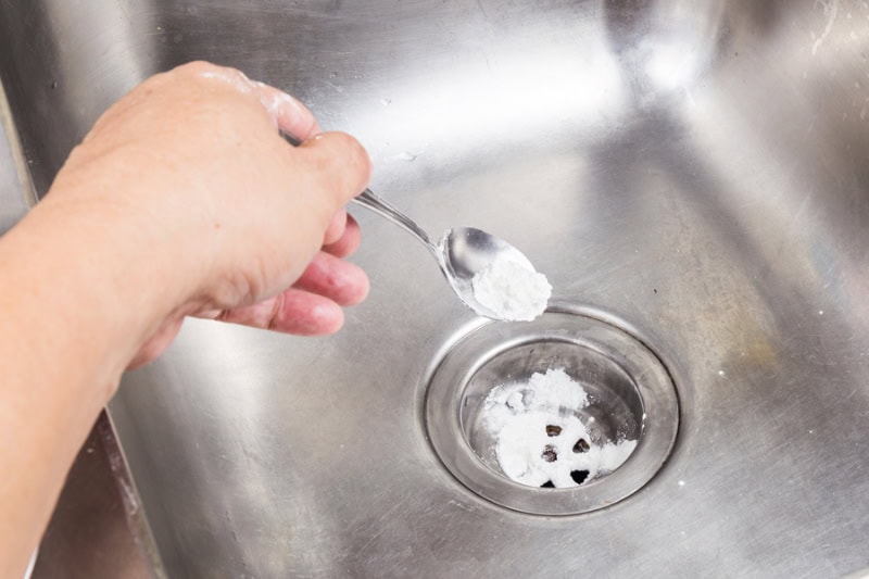 Common Sewer Odors in Your Home: What’s That Smell? Baking soda poured to unclog drainage system at home.