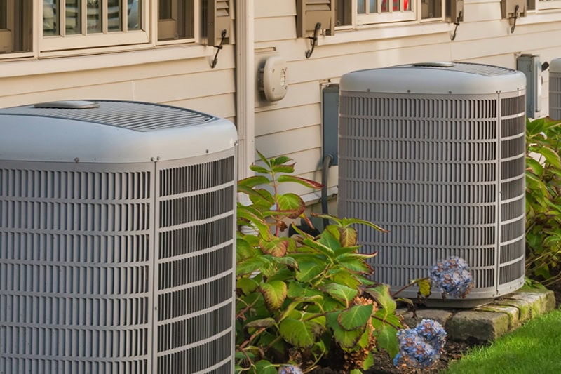 outdoor ac unit sitting outside of a house.